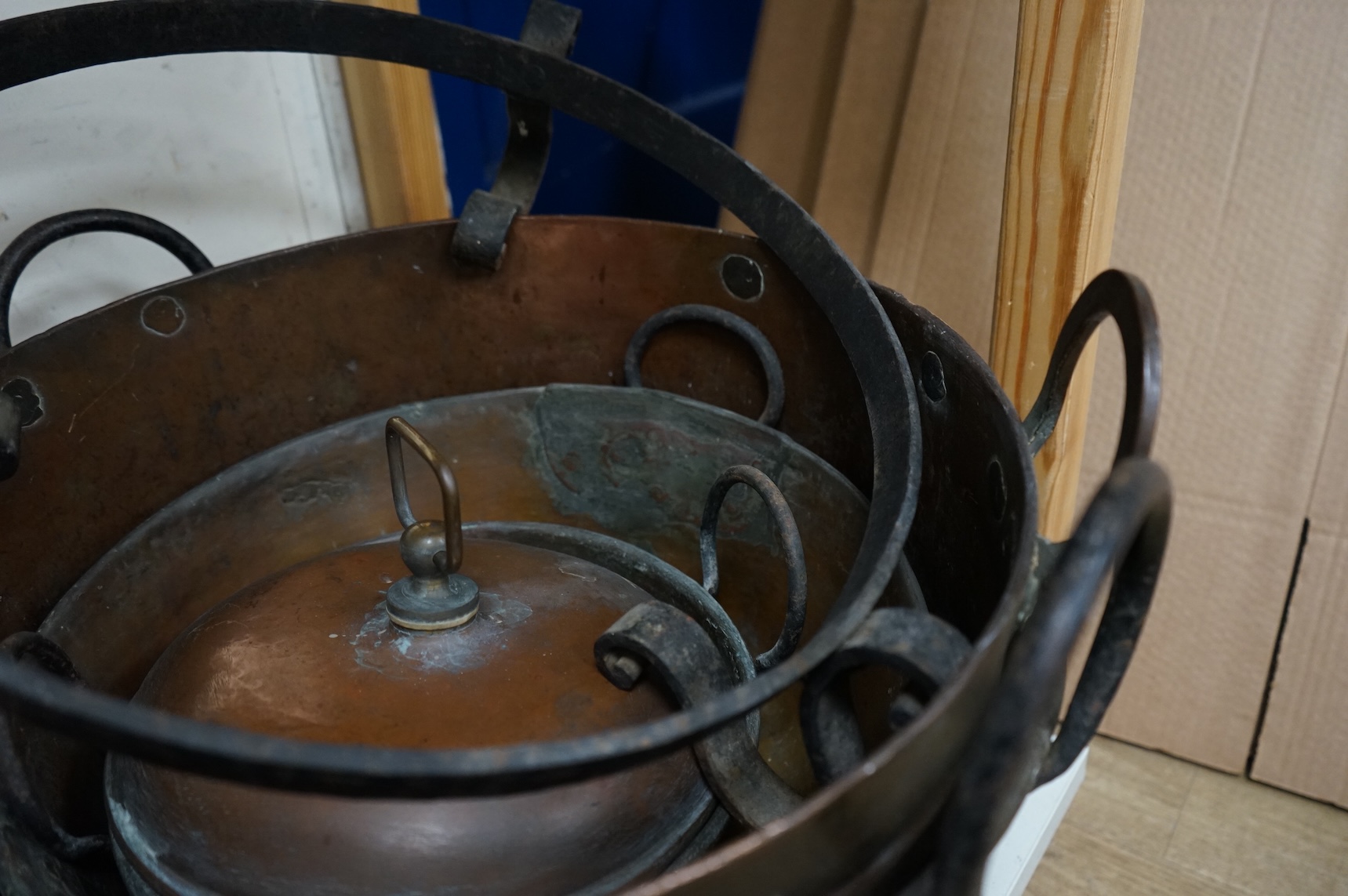 Four copper pans and a copper warming vessel